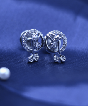 live photography of 925 sterling silver earrings on the blue fabric.