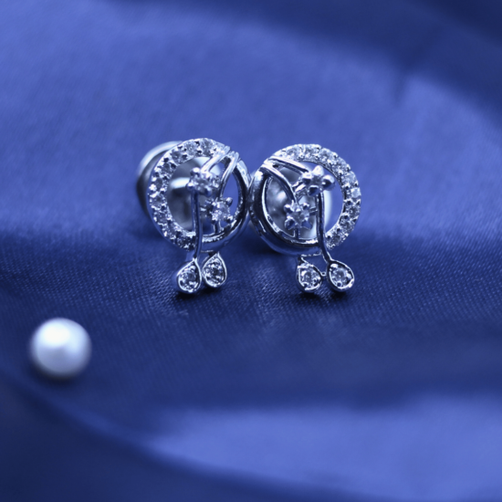 live photography of 925 sterling silver earrings on the blue fabric.