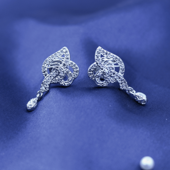 live photography of 925 sterling silver earrings on the blue fabric.